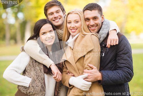 Image of group of friends having fun in autumn park