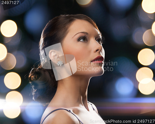 Image of woman in evening dress wearing diamond earrings