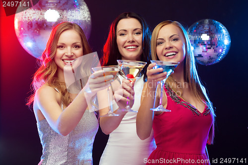 Image of three smiling women with cocktails and disco ball