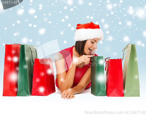 Image of woman in red shirt with shopping bags