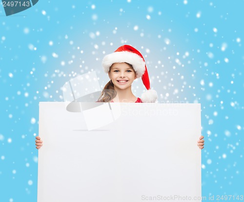 Image of woman in santa helper hat with blank white board