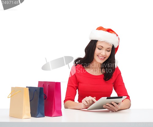 Image of woman with gift box and tablet pc computer