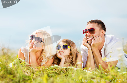 Image of happy family with blue sky and green grass