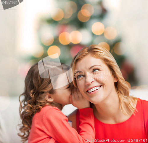 Image of mother and daughter whispering gossip