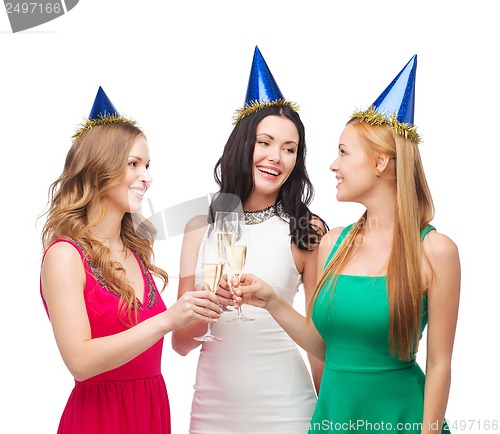 Image of three women wearing hats with champagne glasses