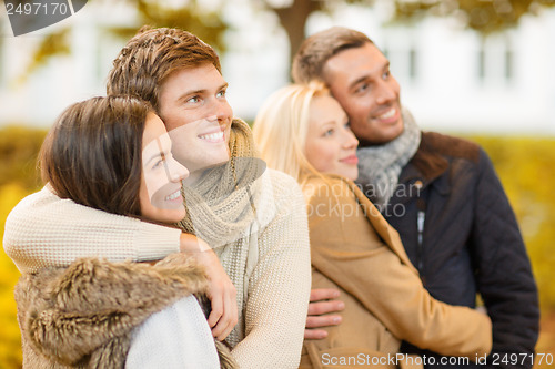 Image of group of friends having fun in autumn park