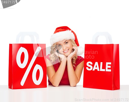 Image of woman in red dress with shopping bags