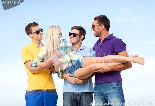 Image of group of friends having fun on the beach