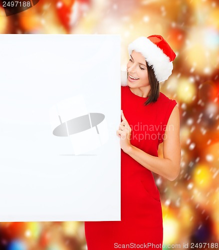 Image of woman in santa helper hat with blank white board