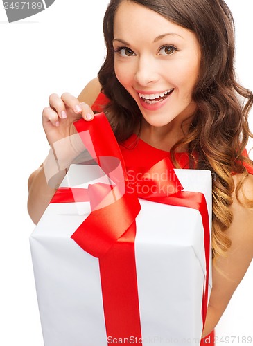 Image of smiling woman in red dress with gift box