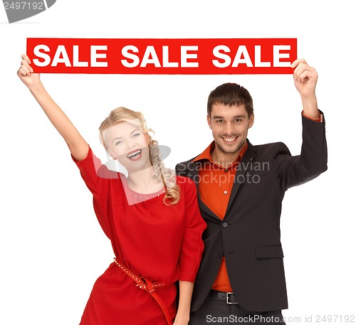 Image of woman and man with red sale sign