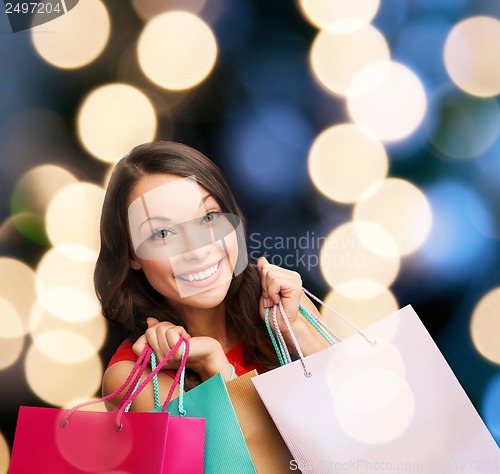 Image of woman in red dress with shopping bags
