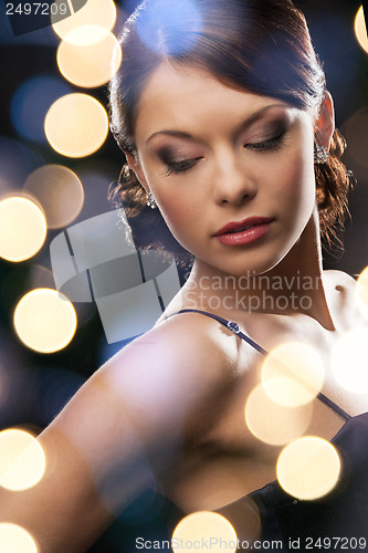 Image of woman in evening dress wearing diamond earrings