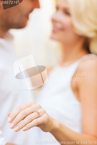 Image of romantic man proposing to beautiful woman