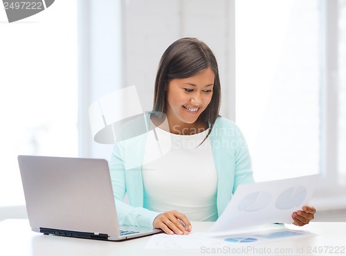 Image of asian businesswoman with laptop and documents