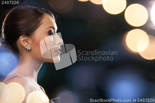 Image of woman in evening dress wearing diamond earrings