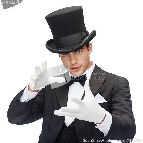 Image of magician in top hat showing trick