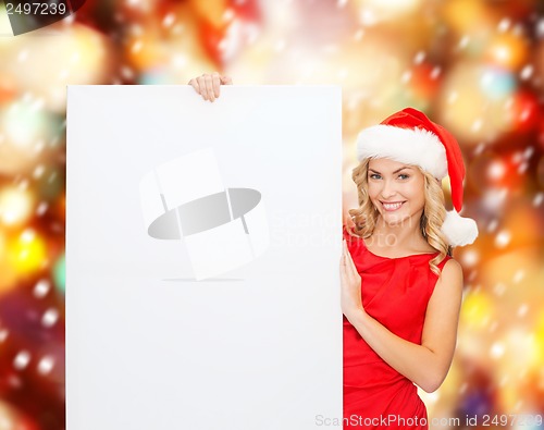 Image of woman in santa helper hat with blank white board