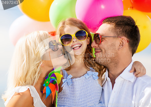 Image of family with colorful balloons