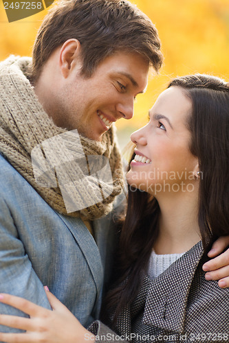 Image of romantic couple kissing in the autumn park