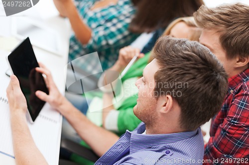 Image of students looking at tablet pc at school