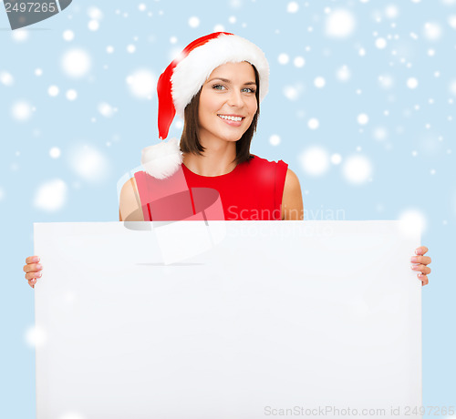 Image of woman in santa helper hat with blank white board