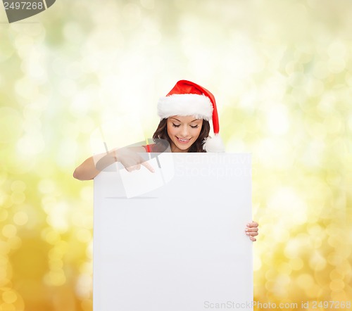 Image of woman in santa helper hat with blank white board