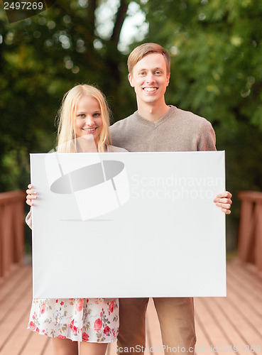 Image of romantic couple with blank white board