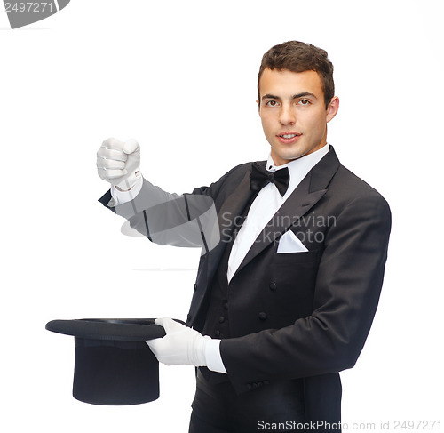 Image of magician in top hat showing trick