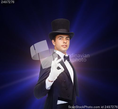 Image of magician in top hat showing trick