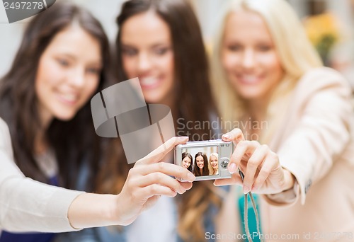 Image of beautiful girls taking picture in the city