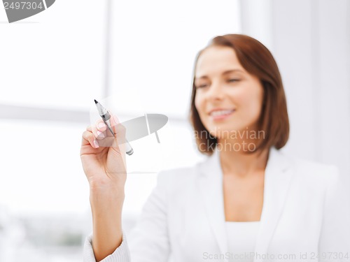 Image of businesswoman writing something in the air