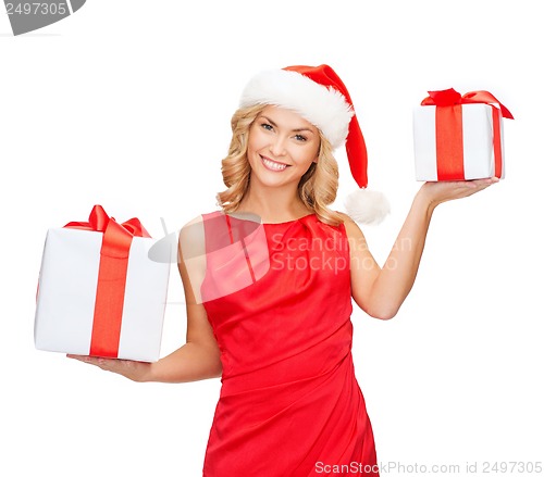 Image of woman in santa helper hat with many gift boxes