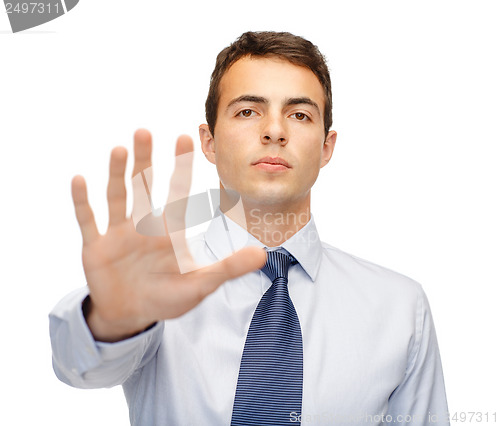 Image of attractive buisnessman making stop gesture