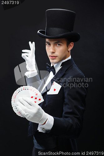 Image of magician showing trick with playing cards