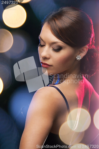 Image of woman in evening dress wearing diamond earrings