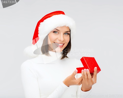 Image of smiling woman in santa helper hat with gift box