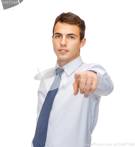 Image of friendly young buisnessman pointing finger