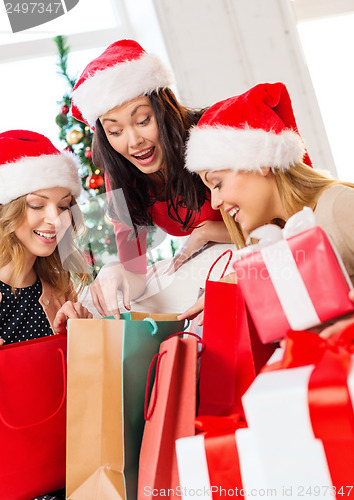 Image of women in santa helper hats with shopping bags