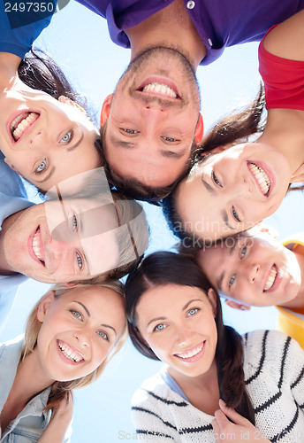 Image of group of teenagers looking down