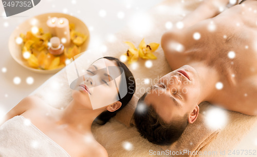 Image of couple in spa salon lying on the massage desks