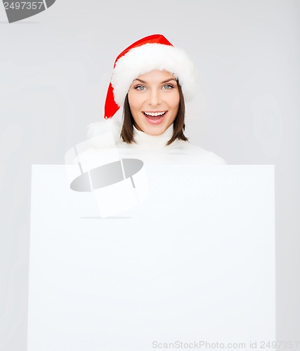 Image of woman in santa helper hat with blank white board