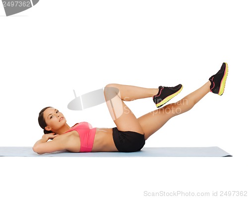 Image of sporty woman doing exercise on the floor