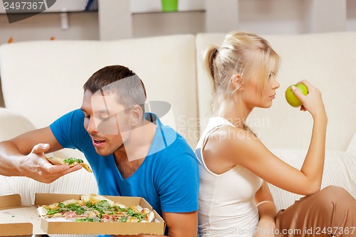 Image of couple eating different food