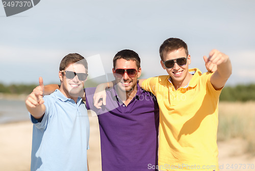 Image of group of friends having fun on the beach