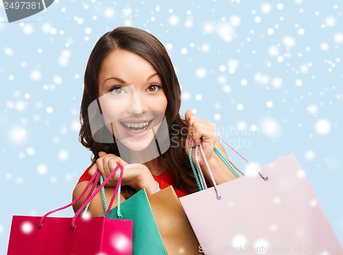 Image of woman in red dress with shopping bags