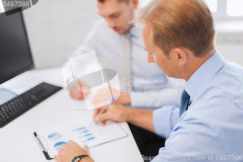 Image of businessmen with notebook on meeting