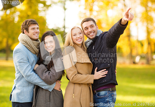 Image of group of friends having fun in autumn park