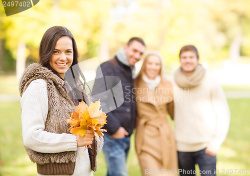 Image of group of friends having fun in autumn park