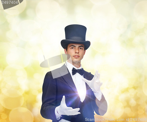 Image of magician in top hat showing trick